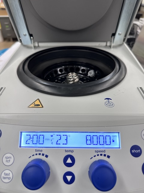 An open centrifuge set to 8000 rpm for two minutes