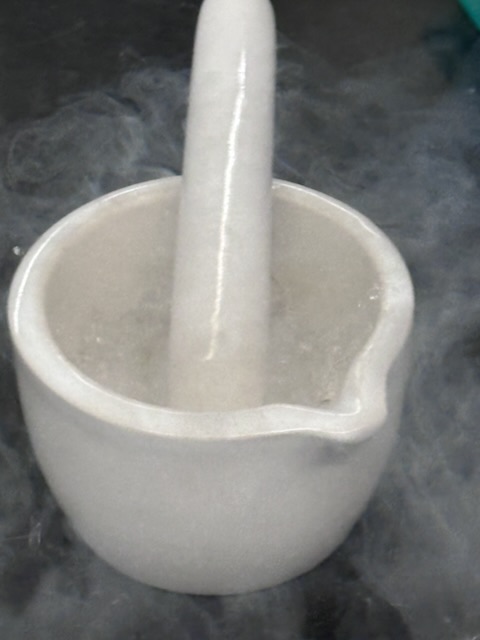 A mortar and pestle smoking with liquid nitrogen